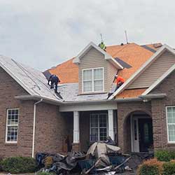 two men working on a roof