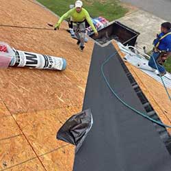 two men working on a roof