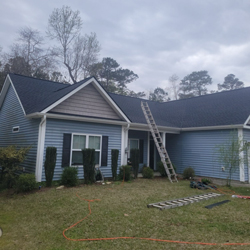 two roofers installing new gray shingles